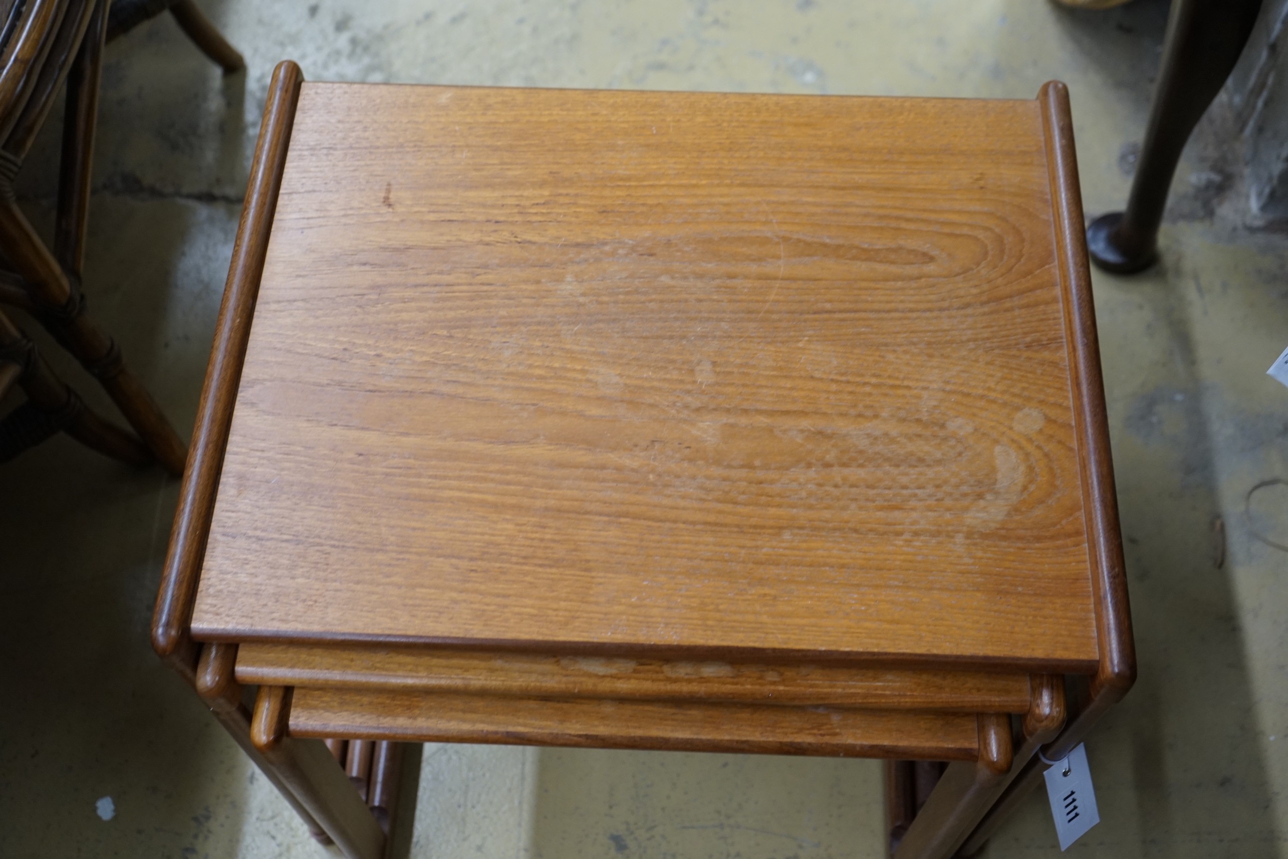 A mid century design nest of three rectangular teak tea tables, width 54cm, depth 43cm, height 48cm